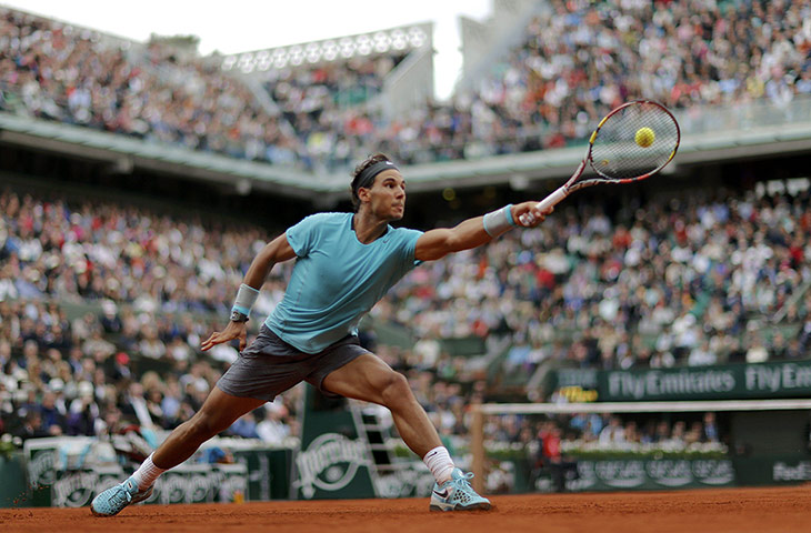20 photos: Rafael Nadal hits a return to Dominic Thiem at the Roland Garros stadium