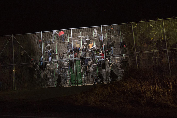 20 photos: Sub-Saharan migrants scale a metallic fence dividing Morocco and Melilla