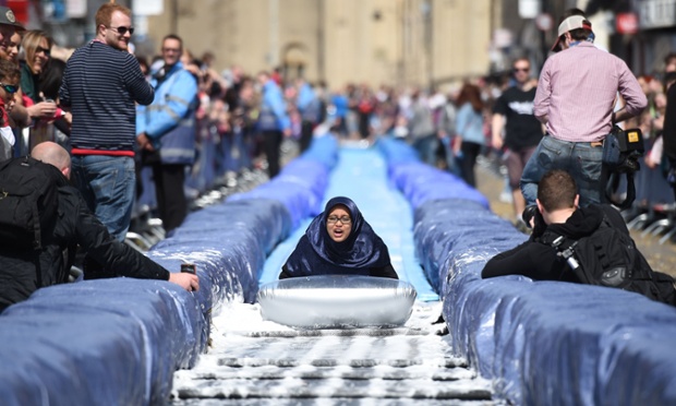 A participant takes part in the Bristol Park and Slide project, an interactive temporary  installation by artist Luke Jerram set up in Park Street