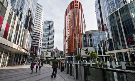 Pedestrians walk through the Sanlitun Village shopping district in Beijing, China