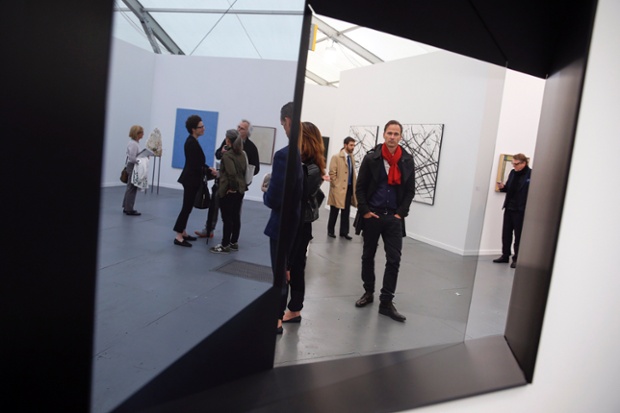 Frieze New York 2014: A visitor is reflected in an installation.