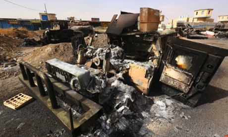 Burnt vehicles belonging to Iraqi security forces are pictured at a checkpoint in east Mosul, one day after radical Sunni Muslim insurgents seized control of the city, June 11, 2014.