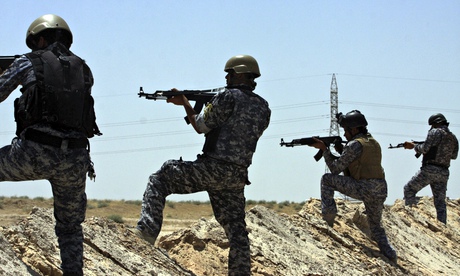 Iraqi security forces patrol near the border between Karbala province and Anbar province today