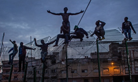 Migrants attempt to cross border from Morocco into Spain in pictures