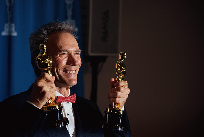 Clint Eastwood: Clint Eastwood holding Academy Awards