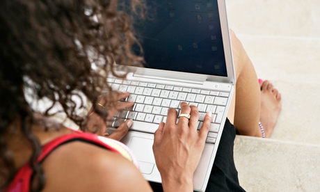 Young woman typing on laptop