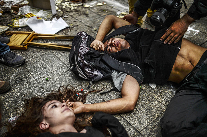20 Photos: Protesters on the ground as riot police fire teargas in Istanbul