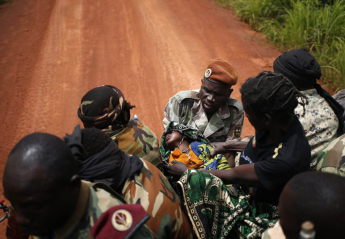 20 Photos: Seleka fighters transport a sick child to her mother to a village