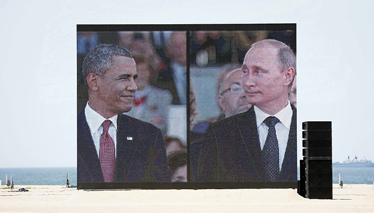 20 Photos: A huge video screen on Sword Beach shows Barack Obama and Vladimir Putin