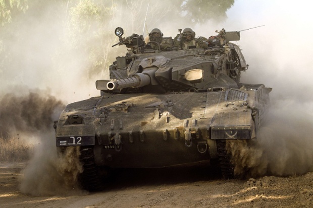 An Israeli Merkava tank rolls along the southern Israeli border with the Gaza Strip.