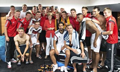 Angela Merkel poses with German team after Portugal win