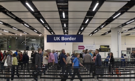Border Force check the passports of passengers arriving at Gatwick Airport.
