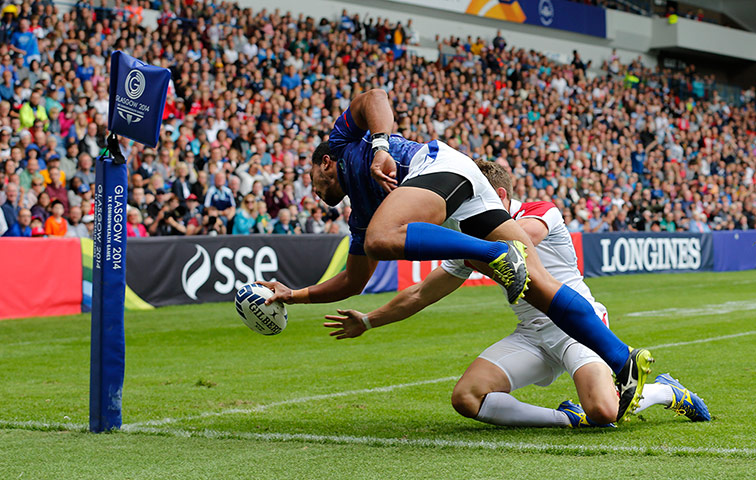 Rugby Sevens TJ: Lio Lolo of Samoa dives over Philip Burgess of England to score