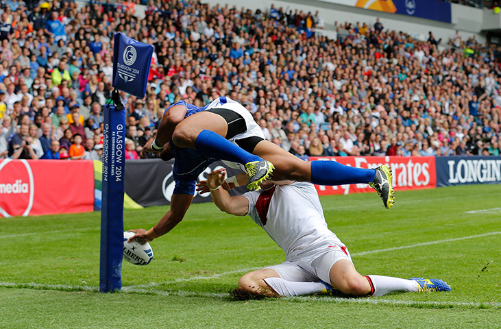 Rugby Sevens TJ: Lio Lolo of Samoa dives over Philip Burgess of England to score