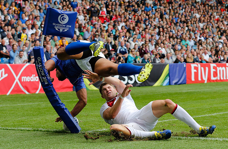 Rugby Sevens TJ: io Lolo of Samoa dives over Philip Burgess of England to score