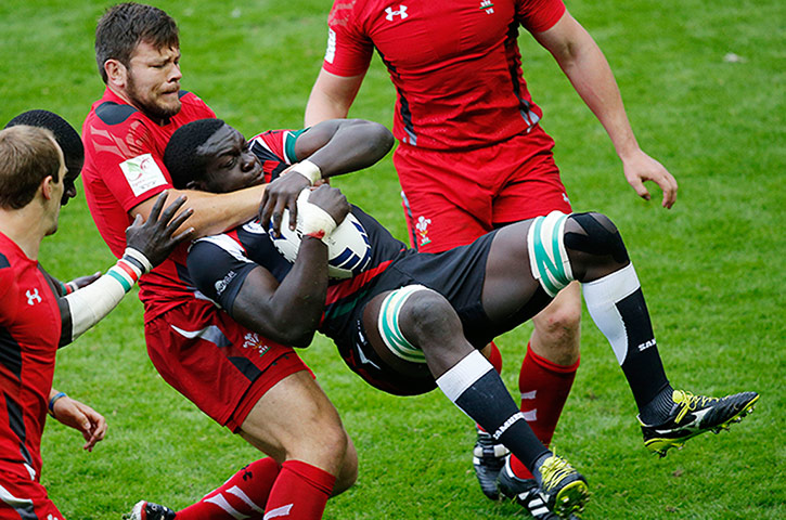 Rugby Sevens TJ: Adam Thomas of Wales catches Oscar Ouma Achieng of Kenya