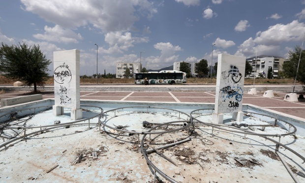 Tthe remains of a fountain decorated with the Olympic rings and graffiti-defaced marble blocks dedicated to Greek Olympic medal winners are seen at the Olympic village.