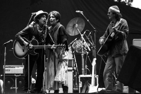 Baez appearing on stage with Bob Dylan and Carlos Santana in 1984