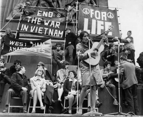 Joan Baez plays in Trafalgar Square, during a protest organised against the war in Vietnam in 1965