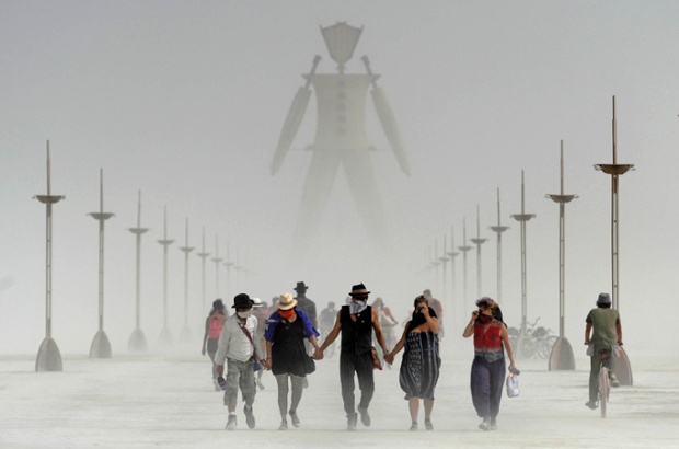 Burning Man participants walk through the dust on the Black Rock Desert of Gerlach.