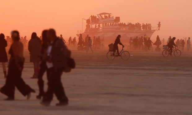 Mutant vehicles and participants make their way across the Playa.