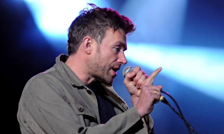 Damon Albarn in profile singing into a microphone