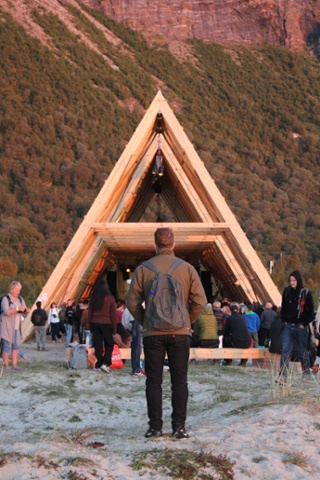 A man watches a performance at SALT’s main stage, one of three wooden prisms built specifically for the site. The structures are based on traditional fish-drying racks from the region.