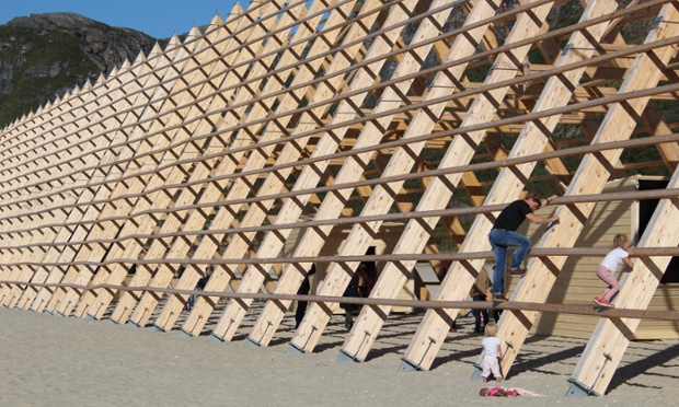 Visitors to SALT festival attempt to climb one the largest of the three wooden prisms on the site. Lots of families attended the opening weekend.
