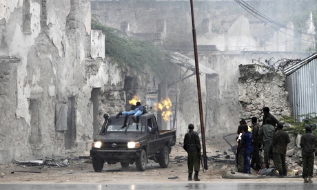 A Somali government soldier fires at al-Shabaab after rebels attacked Mogadishu’s Godka Jilacow jail