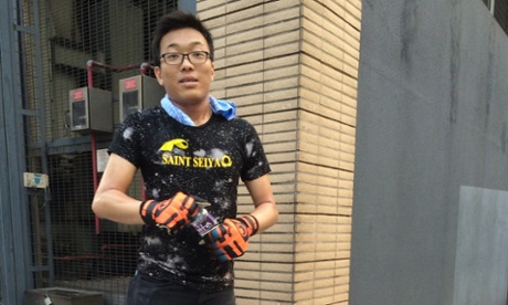 Casar Leung helps clean the street of rubbish