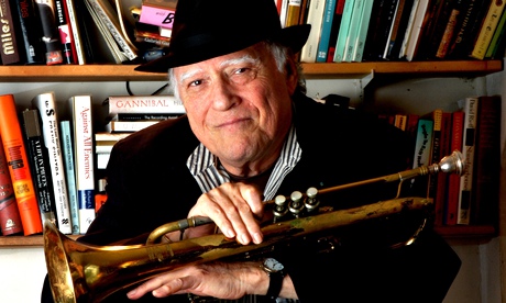Writer and musician Mike Zwerin poses with his bass trumpet