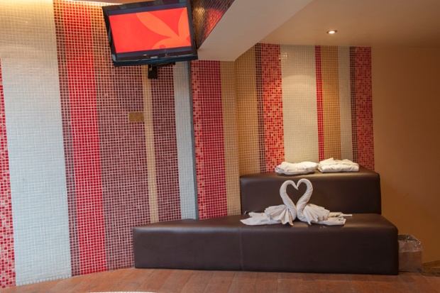 Origami sheets created into the shape of two loving swans.