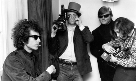 Dylan with film-maker DA Pennebaker in the background shooting the documentary Don't Look Back.