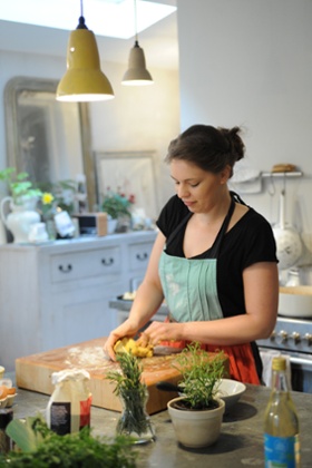 a lady kneading pasta in her kitchen