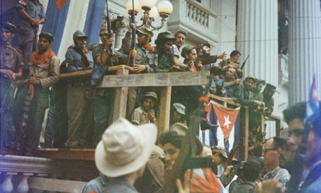 Fidel Castro speaks from a makeshift balcony draped with Cuban flags in Santa Clara en route to entry into Havana.