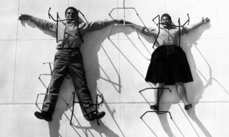 Grounded: Charles and Ray Eames posing with chair bases.