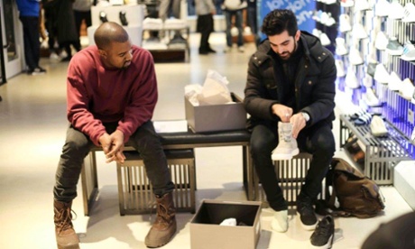 Kanye West tries his hand as a shop assistant