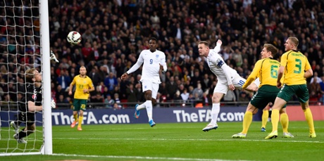 Wayne Rooney nods in England's opener after Danny Welbeck's shot across goal is saved by the Lithuanian keeper.