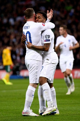 Goalscorer Raheem Sterling gets a congratulatory hug from Wayne Rooney.