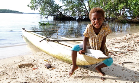 Girl on an outrigger canoe on Anelaua island, Papua New Guinea.