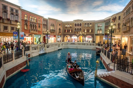Tourists take a gondola ride inside The Venetian.