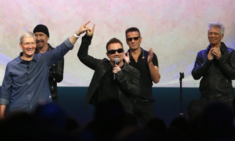 Apple CEO Tim Cook (L) with Bono and the rest of U2 as they unleash their album at the Apple launch event in 2014.