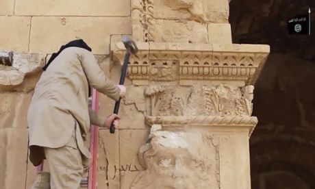 A militant attacking an ancient wall in Hatra.