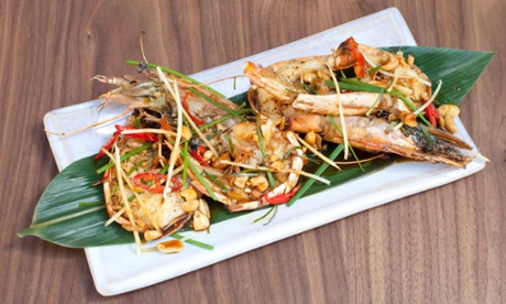 'Big tiger prawns under a deep leaf fall of fresh green herbs and crushed peanuts.'