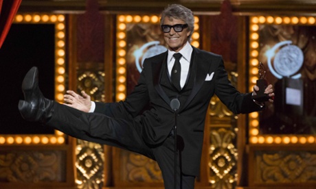 Actor Tommy Tune, recipient of the Lifetime Achievement Award, kicks in the air after being presented the award.