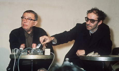 PARIS - FEBRUARY :  French existentialist philosopher and writer Jean-Paul Sartre (L,1905-80) and French film director Jean-Luc Godard, one of the leaders of French “nouvelle vague” cinema, answer the media in February 1971 in Paris.