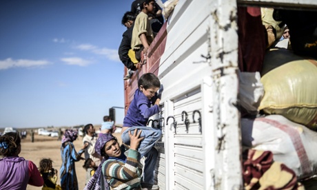 Kurdish refugees get on a bus in Turkey having fled the civil war in Syria.