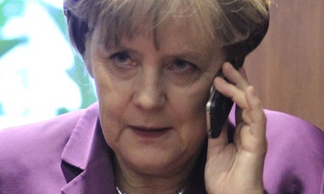 Germany's Angela Merkel using her mobile phone