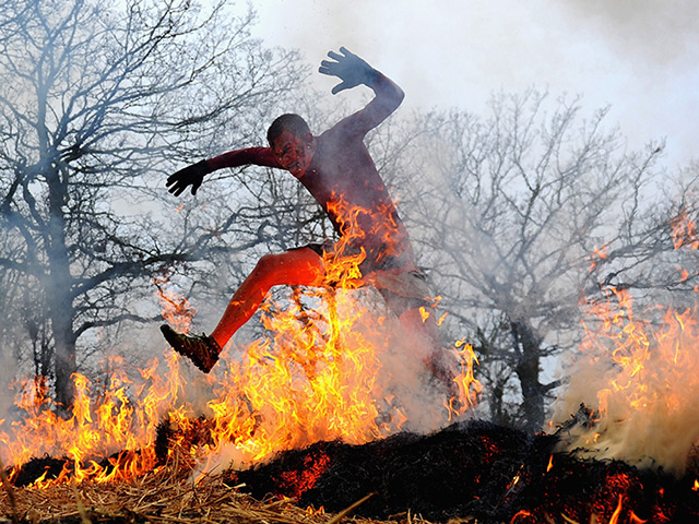 Tough Guy: A man runs through fire during the Tough Guy Challenge 2012