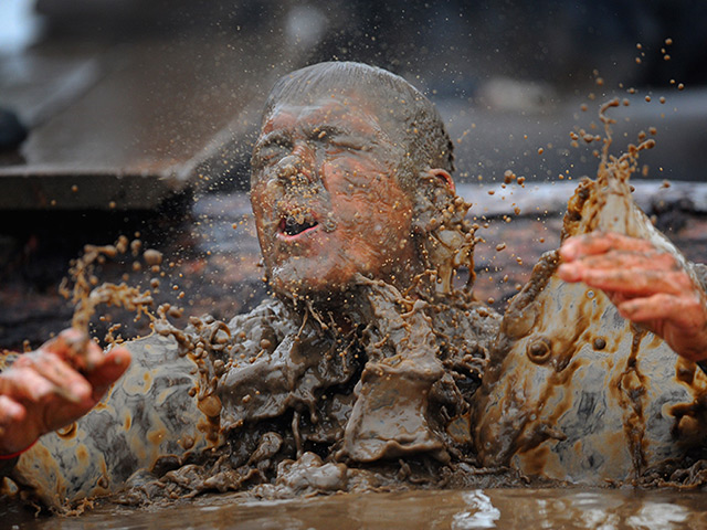 Tough Guy: A mud-spattered competitor at the Tough Guy Challenge 2012